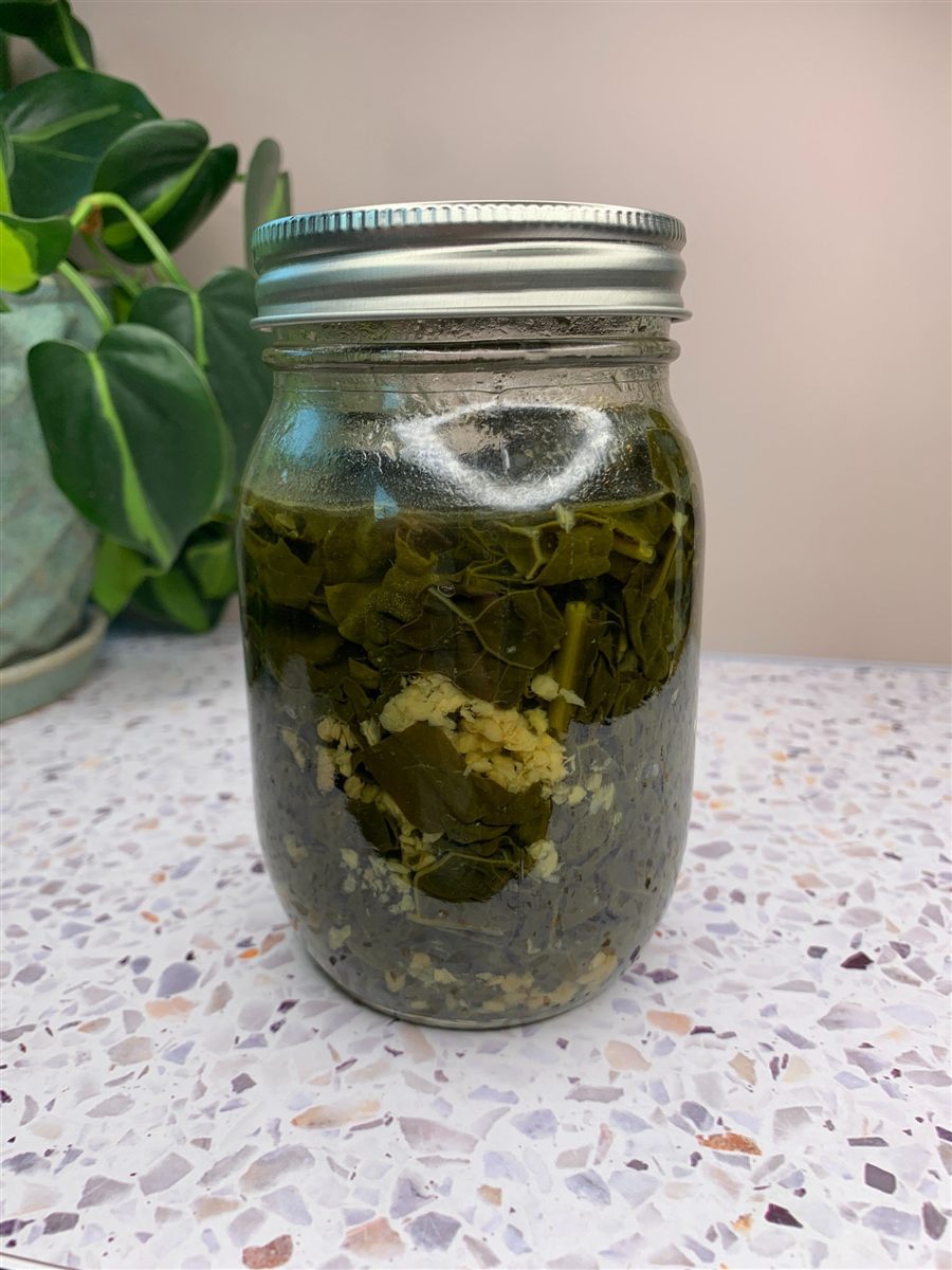 A jar of canned garlic kale.