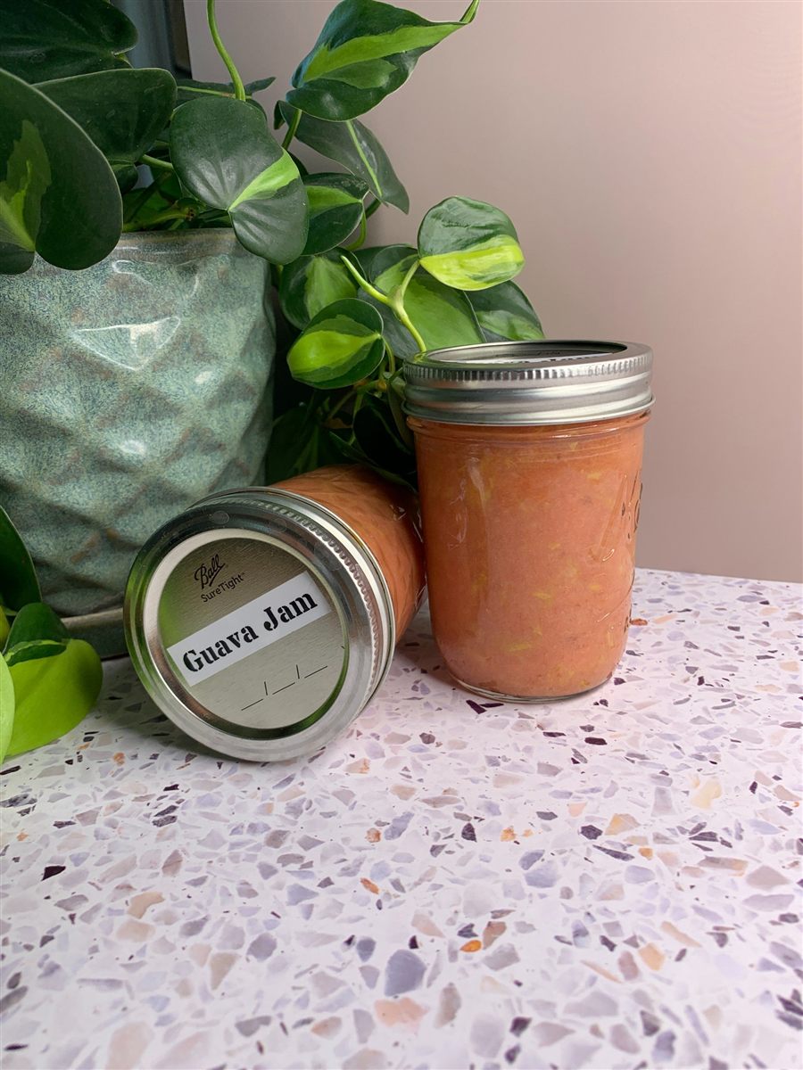 Jars of homemade pink guava jam.