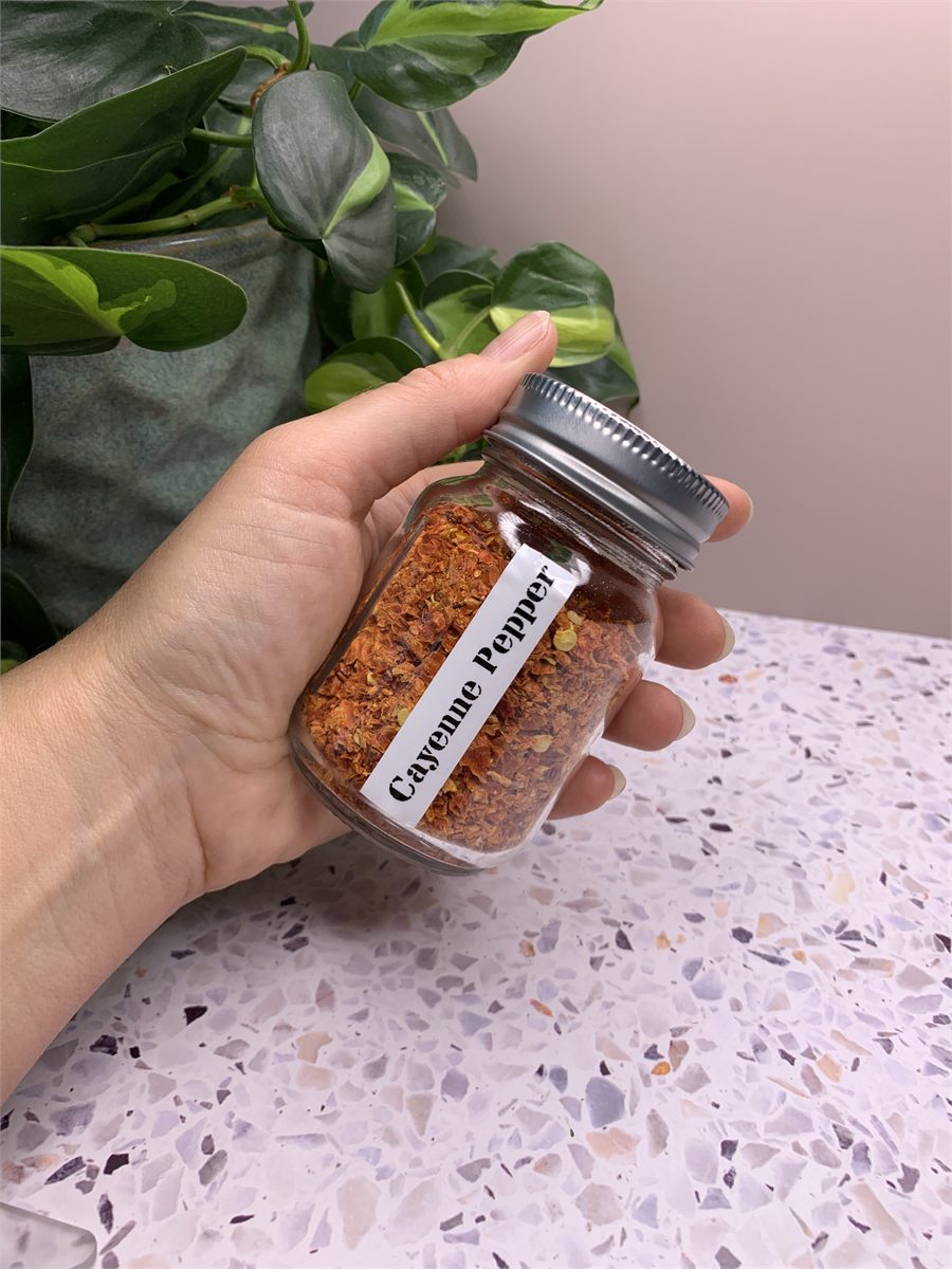 A jar of dried cayenne pepper flake.